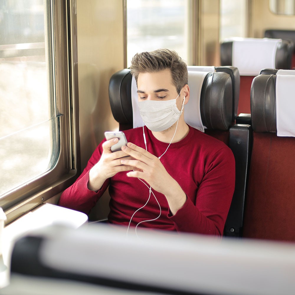 Handsome guy traveling on a train, listening music